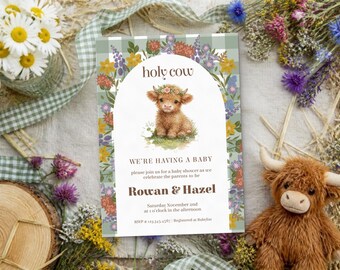 May include: A rectangular baby shower invitation card featuring a green and white gingham border, a central arch, and a watercolor illustration of a highland calf wearing a flower crown. Text reads: holy cow, WE'RE HAVING A BABY, Rowan & Hazel.