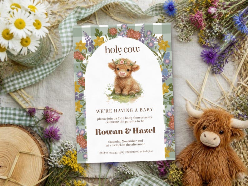 May include: A rectangular baby shower invitation card featuring a green and white gingham border, a central arch, and a watercolor illustration of a highland calf wearing a flower crown. Text reads: holy cow, WE'RE HAVING A BABY, Rowan & Hazel.