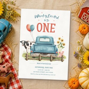 May include: A rectangular invitation card featuring the text Wheel-y Excited to Be ONE, Saturday, June 14th, 11:00 AM - 2:00 PM, 123 Main Street, Anytown, RSVP to Mom @ 555.123.4567 by June 1st, with a blue truck, cow, pig, and sunflowers.