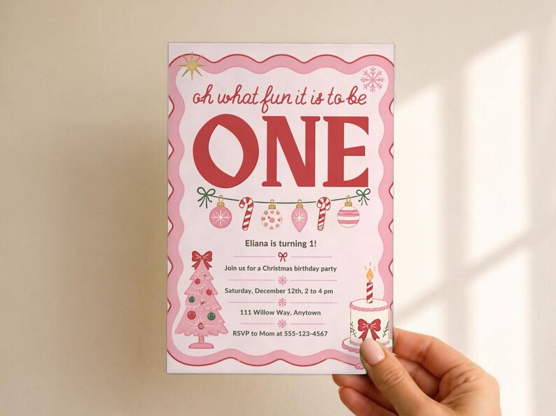 May include: A rectangular birthday invitation card with a pink scalloped border. The text reads: oh what fun it is to be ONE, Eliana is turning 1!, Join us for a Christmas birthday party, Saturday, December 12th, 2 to 4 pm, 111 Willow Way, Anytown, RSVP to Mom at 555-123-4567. Features a pink Christmas tree, cake, and ornaments.