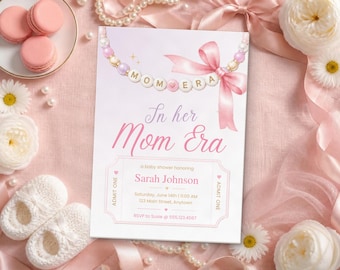 May include: A rectangular baby shower invitation card featuring a pink and white color scheme. The top displays a string of beads with the text MOM ERA and a pink ribbon. The card text reads In her Mom Era, honoring Sarah Johnson.