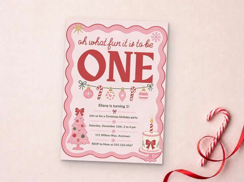 May include: A rectangular birthday invitation card with a scalloped pink border. The text reads: oh what fun it is to be ONE, Eliana is turning 1!, Join us for a Christmas birthday party, Saturday, December 12th, 2 to 4 pm, 111 Willow Way, Anytown, RSVP to Mom at 555-123-4567. Features include a pink Christmas tree, a cake with a candle, and a string of ornaments.