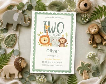 May include: A rectangular invitation card with a scalloped sage green border featuring illustrations of a giraffe, lion, elephant, and monkey. The text reads: Join us to celebrate TWO AT THE ZOO, Oliver, turning two, Saturday, June 14th, 11:00 AM - 2:00 PM, 123 Main Street, Anytown.