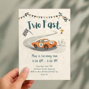 May include: A rectangular invitation card featuring the text Two Fast. and Max is turning two. The design includes an orange race car with the number 2, a winding road, checkered flags, and a gold trophy on a cream-colored background.