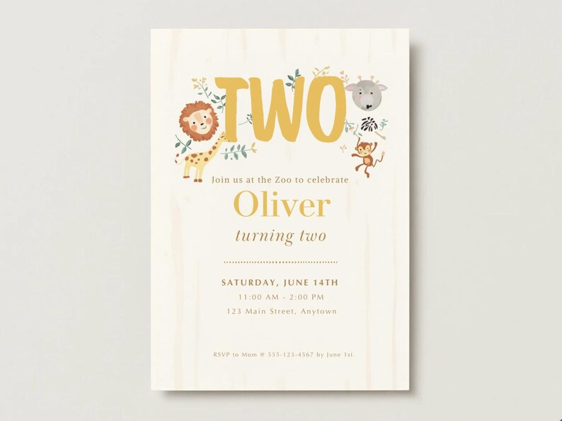 May include: A rectangular birthday invitation card with a light wood grain background. It features the text TWO in large gold letters, surrounded by illustrations of a lion, giraffe, monkey, and zebra. The card includes details for Oliver turning two on Saturday, June 14th, at 123 Main Street, Anytown.