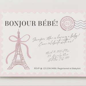 May include: A rectangular baby shower invitation card with a light pink scalloped border. It features a pink Eiffel Tower illustration with a bow, a circular postmark, and text reading BONJOUR B&Eacute;B&Eacute;! Juniper Mac is having a baby! Come celebrate with us! March 10, 2026 at 10am, 123 Waverly Place, Waterton, CO 1293, RSVP @ 123.234.3456 | Registered at Babylist.