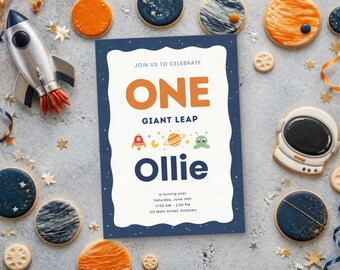 May include: A rectangular birthday invitation card with a dark blue border featuring stars, white center, and orange text reading ONE, followed by GIANT LEAP, small space icons, and the name Ollie in dark blue, with event details below.