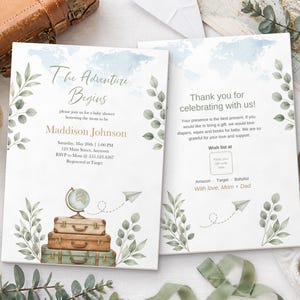 May include: Two white baby shower invitation cards featuring a watercolor world map, green leafy branches, and a stack of three vintage suitcases topped with a globe. The text reads The Adventure Begins, Maddison Johnson, and Thank you for celebrating with us, including details for a baby shower, registry information, and a QR code placeholder.