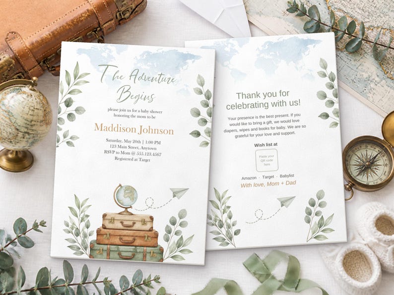 May include: Two white baby shower invitation cards featuring a watercolor world map, green leafy branches, and a stack of three vintage suitcases topped with a globe. The text reads The Adventure Begins, Maddison Johnson, and Thank you for celebrating with us, including details for a baby shower, registry information, and a QR code placeholder.