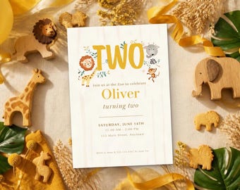 May include: A rectangular birthday invitation card with the text TWO, featuring illustrations of a lion, giraffe, elephant, and monkey. The card includes the name Oliver, the date Saturday, June 14th, and event details, surrounded by wooden animal figures.