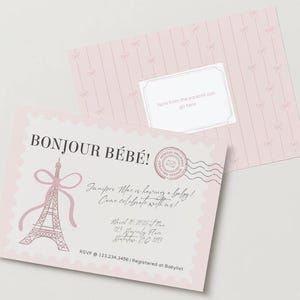 May include: A light pink baby shower invitation card featuring a scalloped edge, a pink Eiffel Tower illustration with a bow, and a circular postmark stamp. The text reads BONJOUR B&Eacute;B&Eacute;!, Juniper Mae is having a baby!, Come celebrate with us!, March 10, 2026 at 11am, 123 Beverly Place, Waterbury, CT 123, RSVP 123.234.3456, Registered at Babylist.