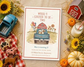 May include: A rectangular birthday invitation card featuring a blue pickup truck carrying a goat, a red barn, and sunflowers. The text reads: WHEEL-Y EXCITED TO BE TWO, Max is turning 2!, Saturday, June 14th, 11:00 AM - 2:00 PM, 123 Main Street, Anytown.
