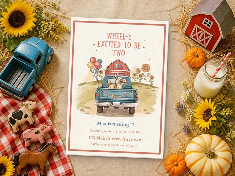 May include: A rectangular birthday invitation card featuring a blue pickup truck carrying a goat, a red barn, and sunflowers. The text reads: WHEEL-Y EXCITED TO BE TWO, Max is turning 2!, Saturday, June 14th, 11:00 AM - 2:00 PM, 123 Main Street, Anytown.