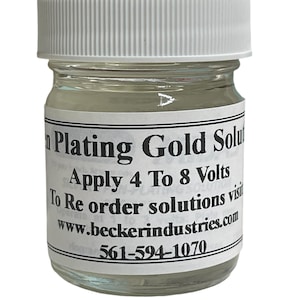 May include: A clear glass bottle with a white lid containing gold plating solution. The label reads "Plating Gold Solution", "Apply 4 To 8 Volts", "To Re order solutions visit www.beckerindustries.com", and "561-594-1070".