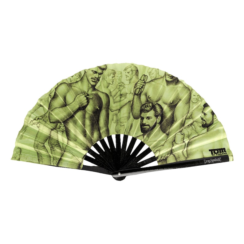 May include: A green and black hand fan with a black handle. The fan features a black and white illustration of a group of men. The fan has the text "Tom of Finland" and "Don't Spill It" printed on it.