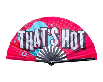 May include: A vibrant pink hand fan with the text "THAT'S HOT" in large white letters. The fan features a black handle and a design with a blue and red background. The fan is open and displayed against a white background.