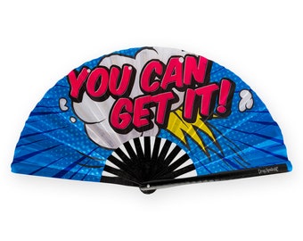 May include: A blue and white hand fan with a black handle. The fan features a comic book style design with the words "You Can Get It!" in pink and yellow.