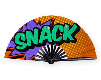 May include: A black and white folding fan with an orange, purple, and green comic book style design. The design features the word "SNACK" in a large, bold font.