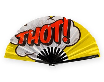 May include: A yellow and white hand fan with a black handle. The fan has a comic book style design with the word "THOT!" in red and black letters.