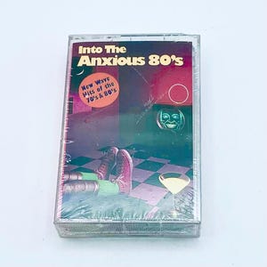 May include: A vintage cassette tape titled "Into The Anxious 80's" with a retro design. The cover features a colorful illustration with a checkered floor, a cocktail, and the text "New Wave Hits of the 70's & 80's."