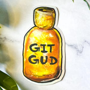 May include: A yellow glass bottle with a black label that says "GIT GUD".