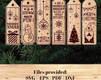 May include: A collection of six wooden Christmas-themed bookmarks. Each bookmark features laser-cut designs of ornaments, snowflakes, gifts, a snowman, a Christmas tree, and a gnome. Text includes "Merry Xmas", "Reading is Snow Much Fun!", and "Be Merry & Bright With a Great Story!"