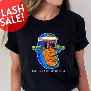 a woman wearing a black shirt with a picture of a hot dog wearing sunglasses
