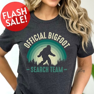 a woman wearing a t - shirt that says official bigfoot search team