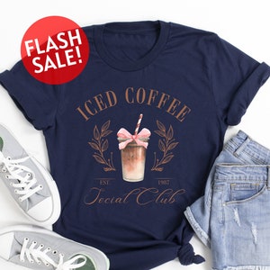 a t - shirt that says iced coffee with a pink bow on it