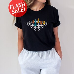a woman wearing a black t - shirt with a checkered design