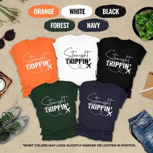 a collection of t-shirts with the text "Straight Tripin'" printed on them, along with various other items such as sunglasses, a clock, a plant, and a notebook.