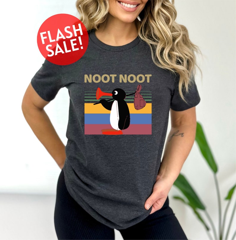 a woman wearing a t - shirt with a penguin on it