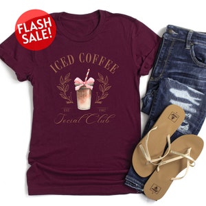 a t - shirt that says iced coffee and a pair of jeans