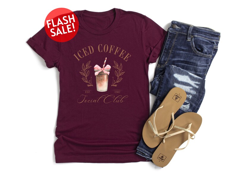 a t - shirt that says iced coffee and a pair of jeans