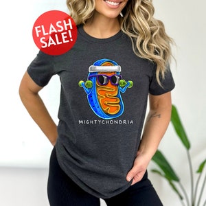 a woman wearing a t - shirt with a picture of a hot dog wearing sunglasses