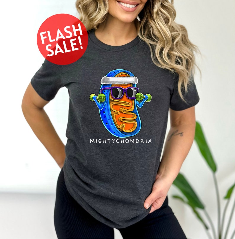 a woman wearing a t - shirt with a picture of a hot dog wearing sunglasses