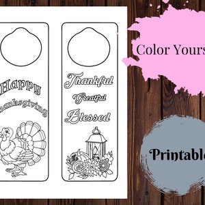 May include: Two printable door hangers with Thanksgiving themes. The left one features a turkey and the text "Happy Thanksgiving". The right one features a lantern and flowers with the text "Thankful, Grateful, Blessed".