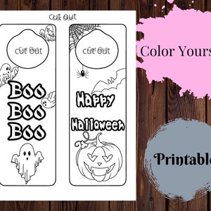May include: Two printable Halloween bookmark designs. The first bookmark features a ghost, three "Boo"s, and a cut-out space. The second bookmark features a pumpkin, a spider web, a spider, a bat, and the text "Happy Halloween". Both bookmarks have a cut-out space at the top.