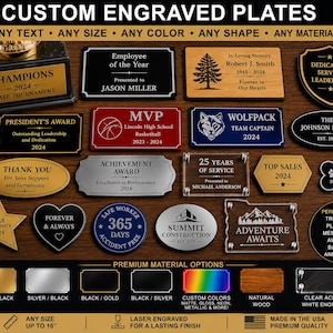 May include: A collection of custom engraved plates in various shapes, colors, and materials including gold, silver, black, wood, and clear acrylic. The plates feature diverse text, logos, and designs for trophies, awards, and memorials.