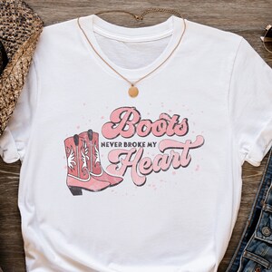 Boots Never Broke my Heart Shirt | Cowgirl T-shirt | Western Short Sleeve | Howdy Pink Cowboy Boots Cotton Jersey | Rodeo Horse Lover Gifts