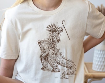 Jesus Riding Monster Shirt | Cool Tee | Jesus T-shirt | Funny Shirt | Christ Tshirt | Christian Shirts | Wild Dinosaur Tee | Religion Gifts
