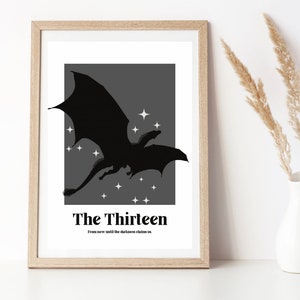 May include: A black and white print of a dragon flying in front of a grey background with white stars. The text "The Thirteen" and "From now until the darkness claims us" is below the dragon.