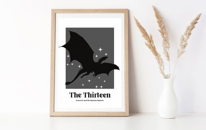 May include: A black and white print of a dragon flying in front of a grey background with white stars. The text "The Thirteen" and "From now until the darkness claims us" is below the dragon.