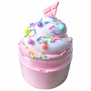 May include: Pink slime in a clear jar topped with white whipped cream, colorful sprinkles, and a pink chocolate bar that says "MILK" three times.