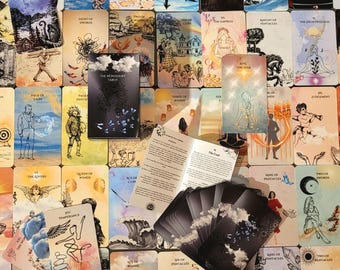 May include: A collection of tarot cards spread out, featuring various illustrated scenes and titles like The Star, The Empress, and The Fool. A black box labeled The Wondersky Tarot and a folded instruction booklet are placed among the cards.
