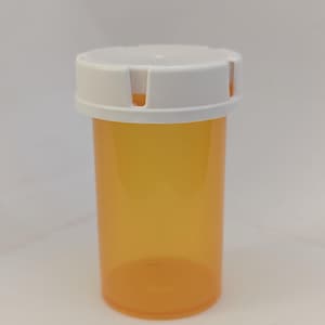 May include: A clear amber plastic bottle with a white child-resistant cap. The bottle has a smooth, rounded shape and is designed for storing pills or other medications.