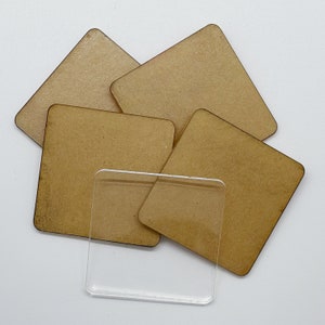 May include: Four brown square wooden coasters with a clear plastic square coaster on top.