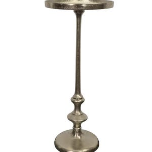 May include: A silver-colored metal plant stand with a round top and a slender, decorative stem. The stand has a circular base and a textured finish, suitable for displaying plants or decorative items. The stand is approximately 28 inches tall.