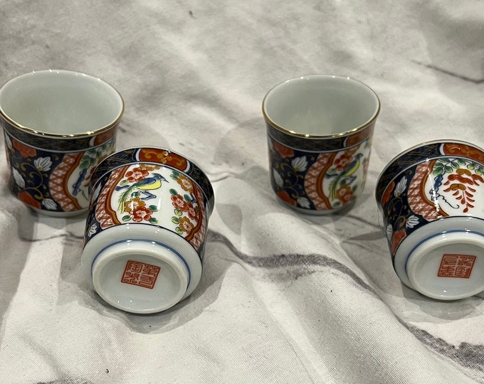 Set of 4 Japanese Ochoko sake cups with traditional design.