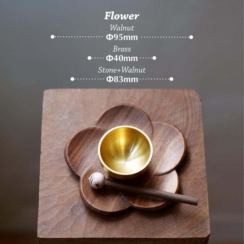 May include: A wooden flower-shaped base with a brass bowl and a wooden mallet. The base is made of walnut and measures 95mm in diameter. The brass bowl is 40mm in diameter. The mallet has a stone and walnut head, 83mm in diameter.